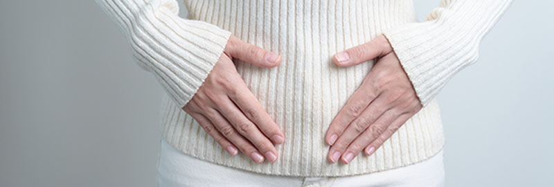 Woman holding her belly. Pregnancy, Reproductive system, menstruation, and gynecology concept